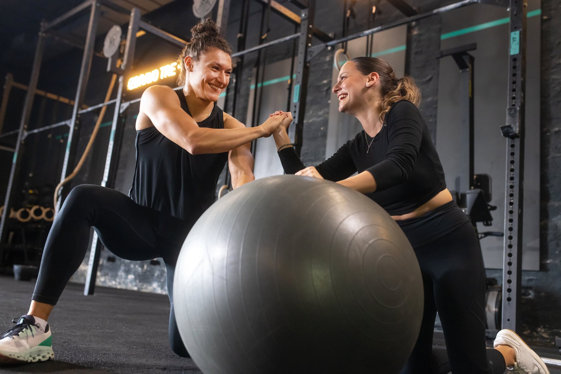 An Elite Training coach guiding a client through a stability-ball exercise