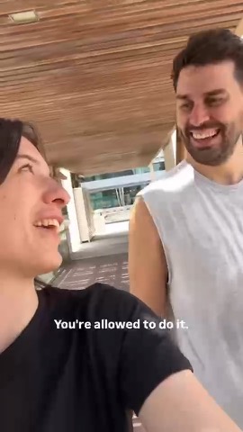 Milana laughing with a male client after a session